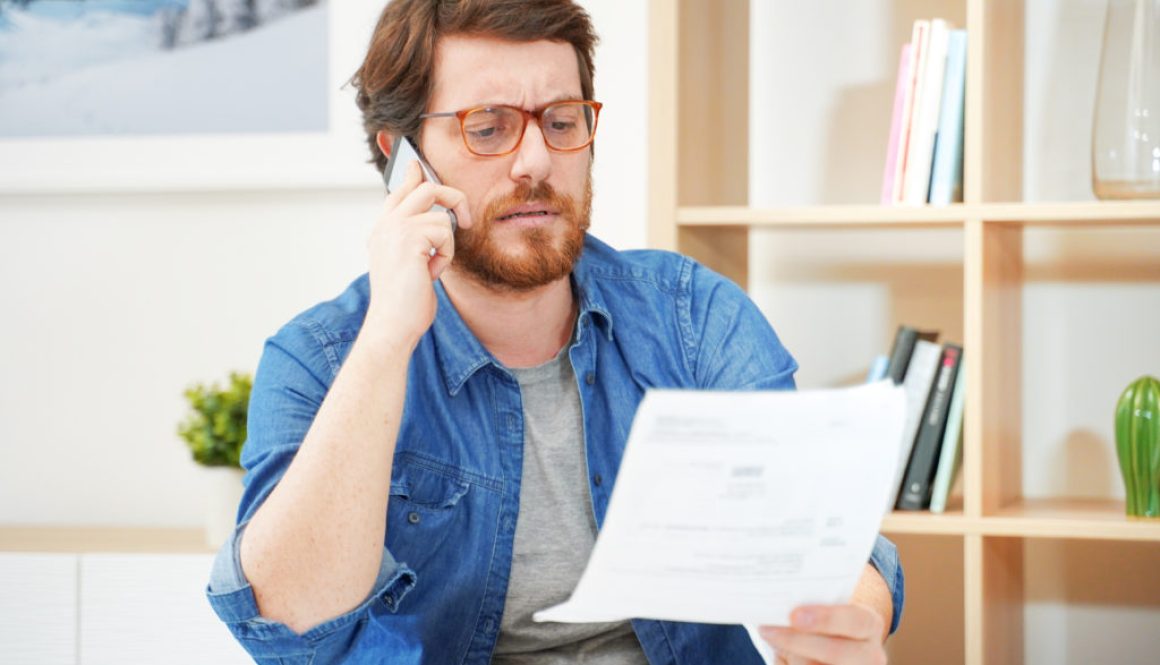 Man calling customer service after unjustified costs complain