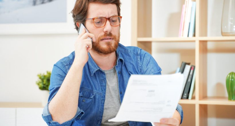 Man calling customer service after unjustified costs complain