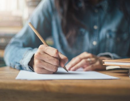 woman writing - settling debt