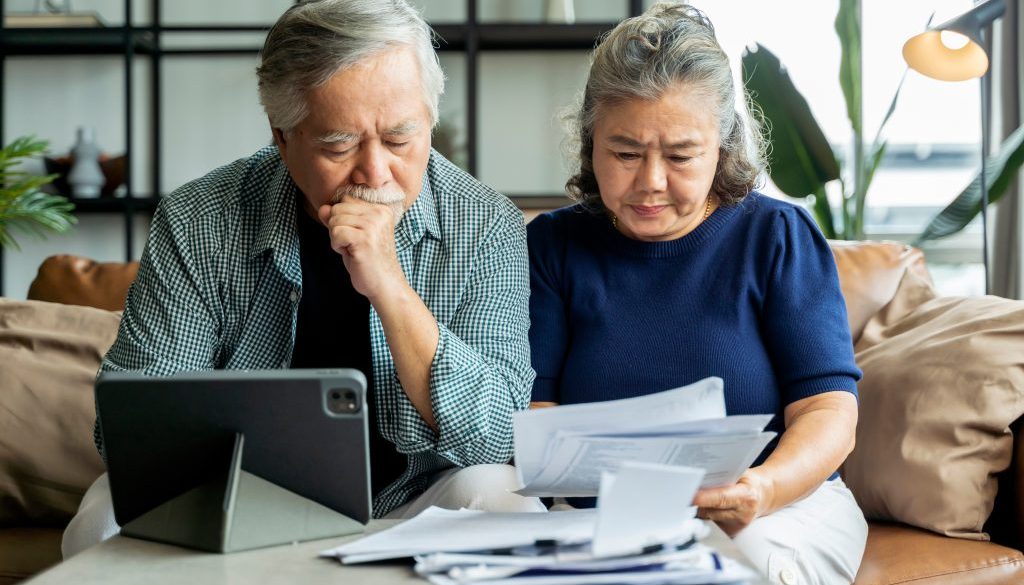 Couple looking at computer - Senior Debt