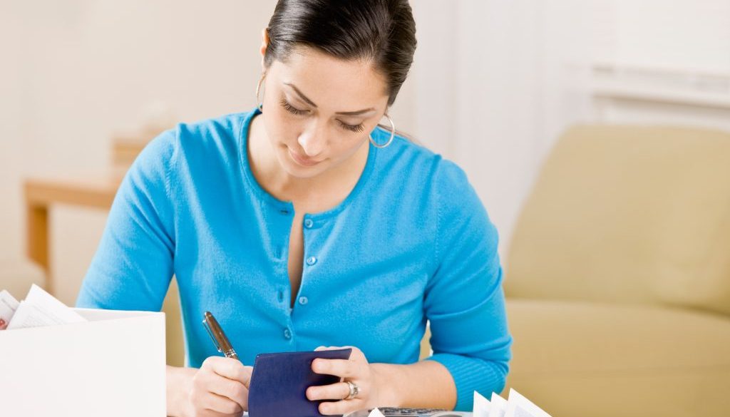 Woman writing check Settling Debt Writing Check