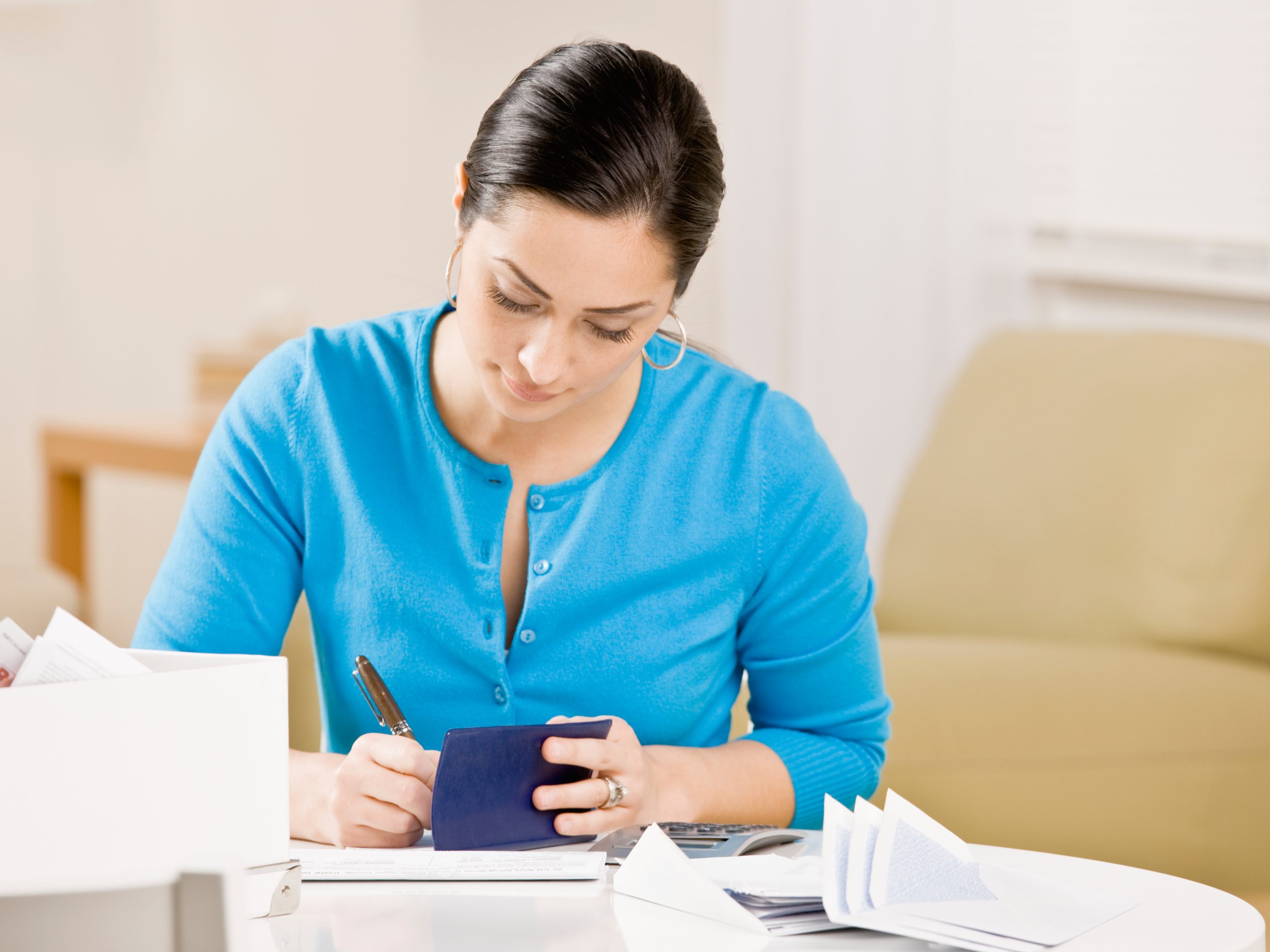 Woman writing check Settling Debt Writing Check