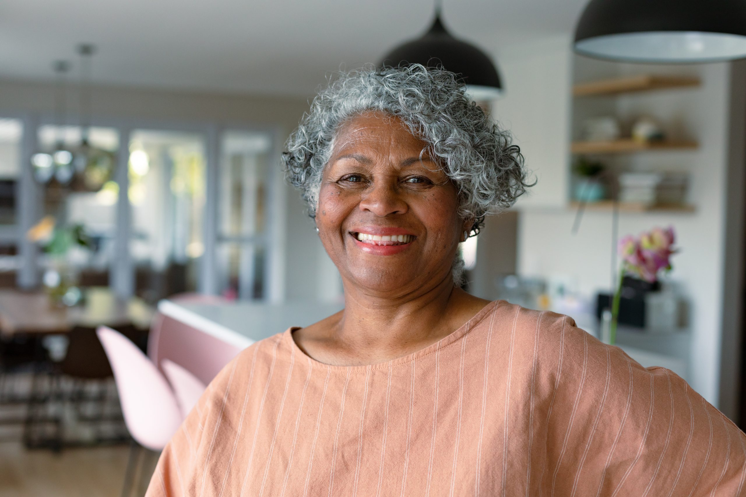 Happy senior woman standing in kitchen