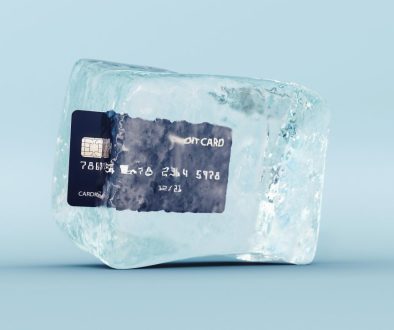 Credit card frozen in ice cube on blue background 3D Rendering