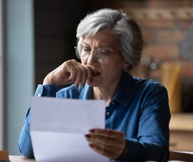 Stressed older woman debt letter