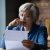 Stressed older woman debt letter