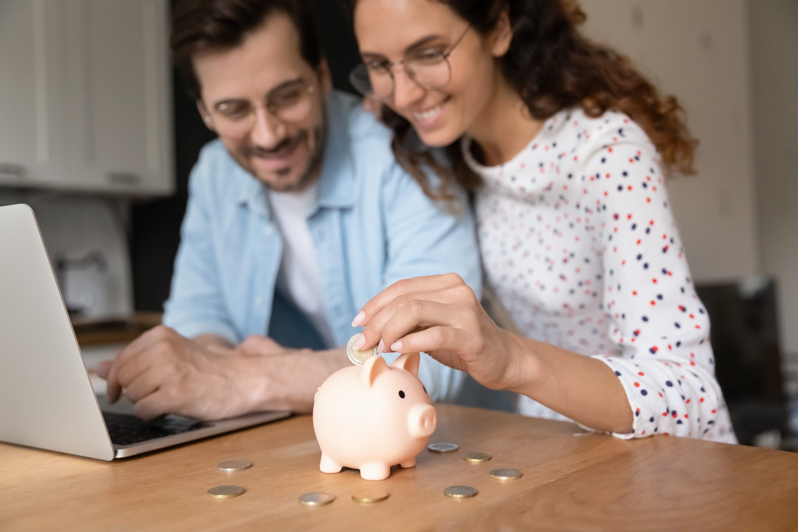 Happy millennial family couple planning future investment.