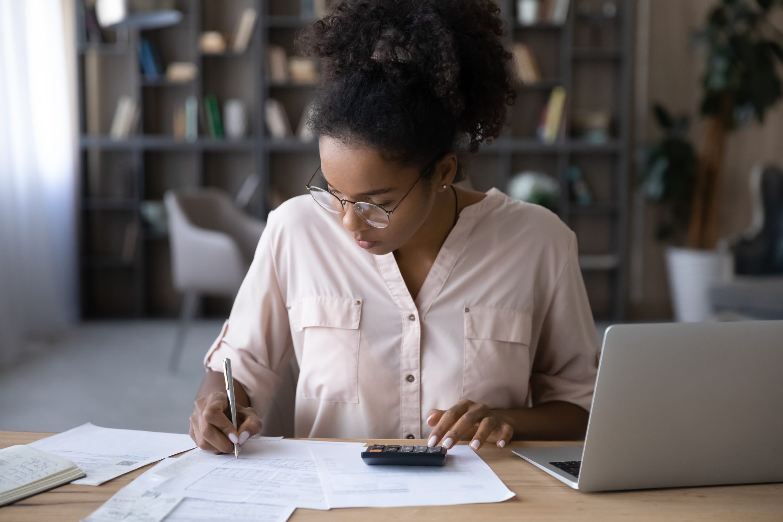 African American woman manage budget paying bills online