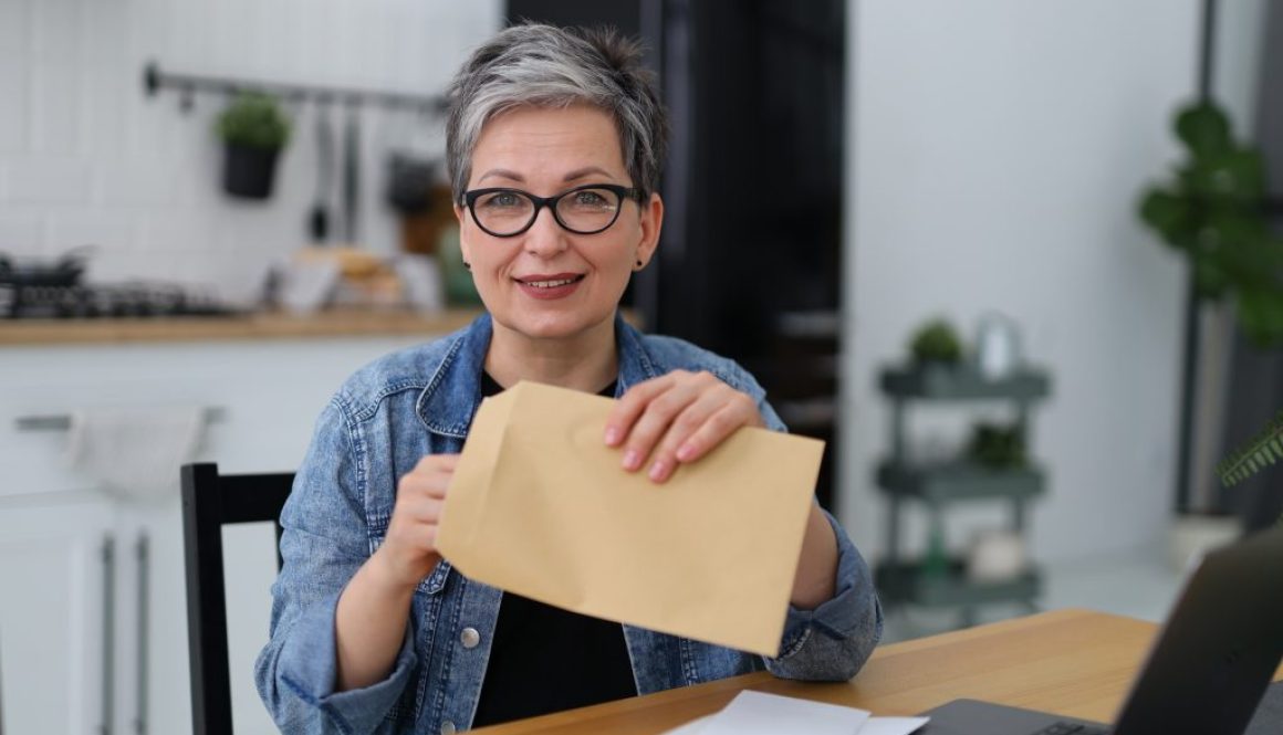 woman holding a postal envelope with mail, financial report.