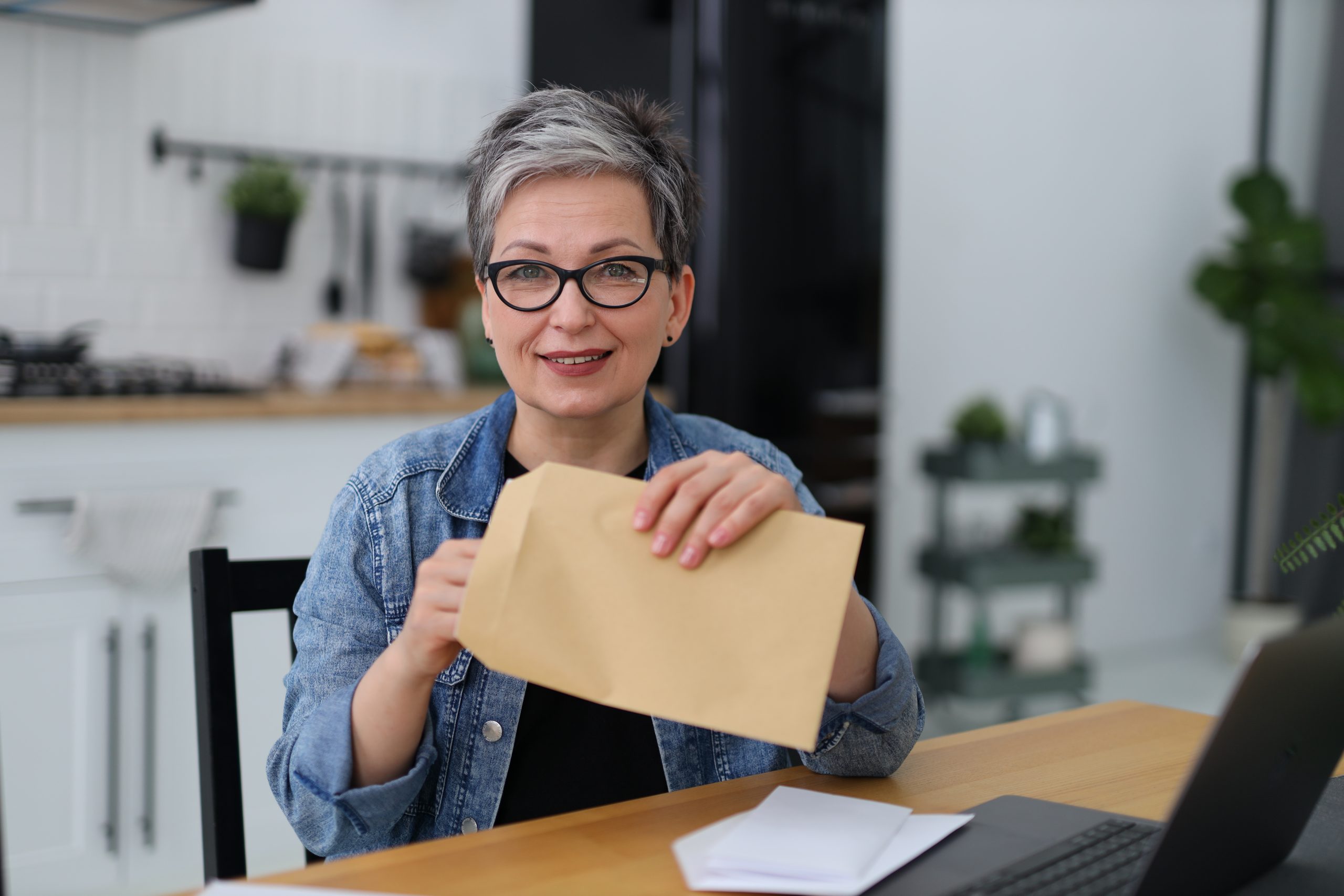 woman holding a postal envelope with mail, financial report.