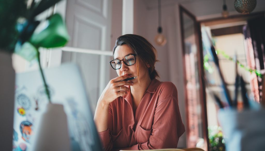 Young businesswoman thinking about something while sitting front