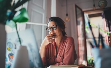 Young businesswoman thinking about something while sitting front