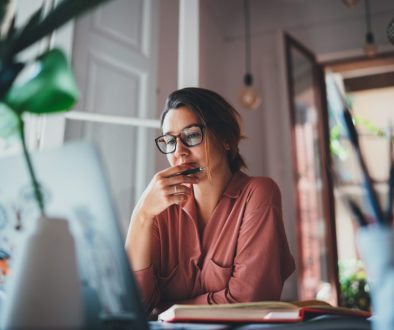 Young businesswoman thinking about something while sitting front