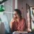 Young businesswoman thinking about something while sitting front