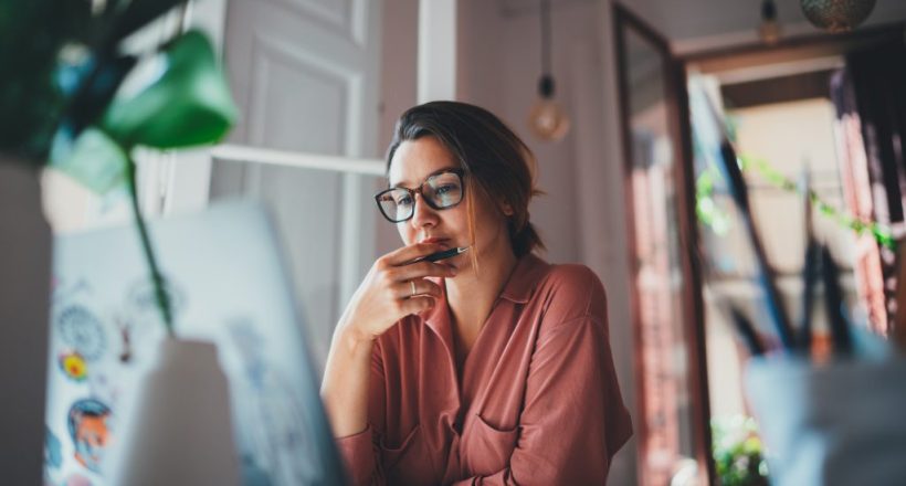 Young businesswoman thinking about something while sitting front