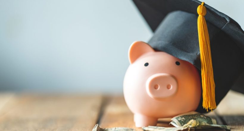 piggy bank With Graduation Cap on old wood,Money saving concept. piggy bank With Graduation Cap on old wood,Money saving concept.