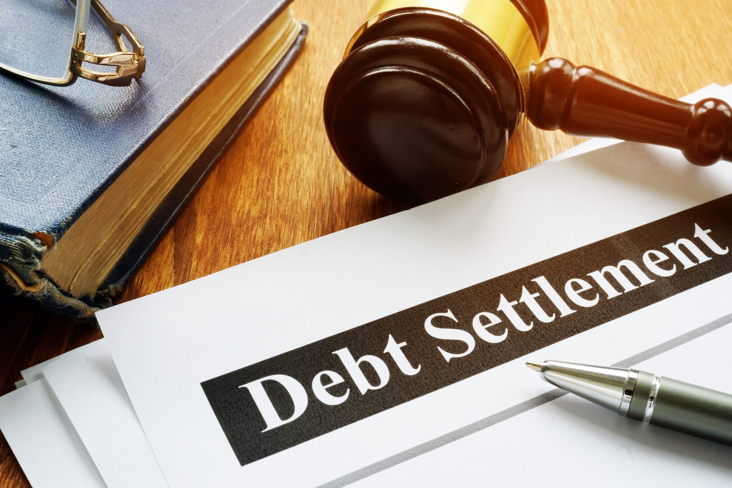 Debt Settlement documents and gavel in the court.