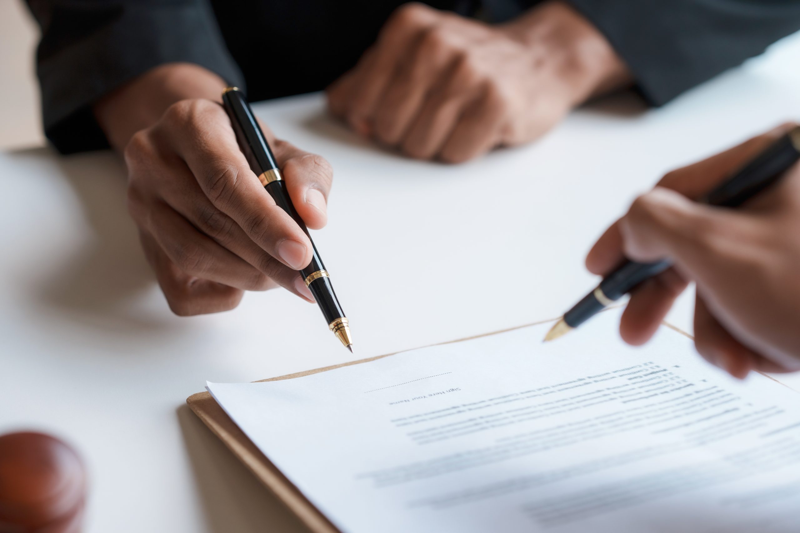 Lawyer and client sign variou financial legal contract to mediat Lawyer and client sign variou financial legal contract to mediat