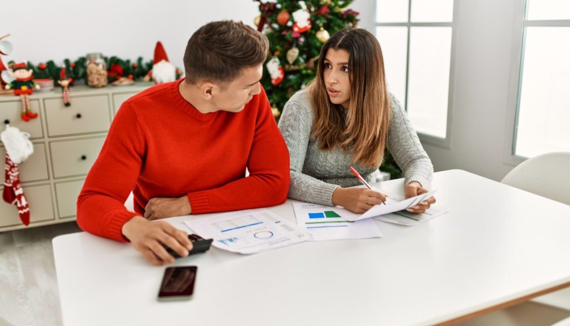 Young couple controlling family economy sitting on the table at home.