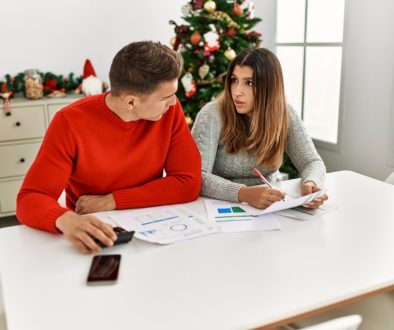 Young couple controlling family economy sitting on the table at home.
