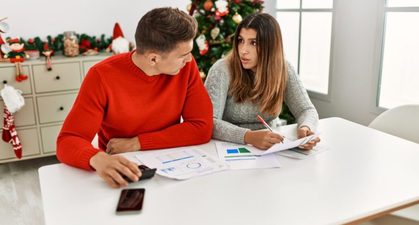 Young couple controlling family economy sitting on the table at home.