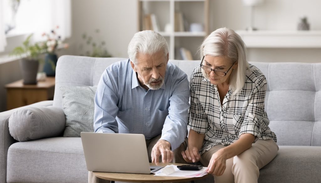 Two-seniors-reviewing-bills-and-debt-