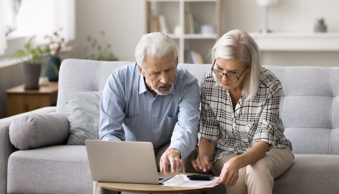 Two-seniors-reviewing-bills-and-debt-