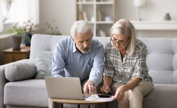 Two-seniors-reviewing-bills-and-debt-