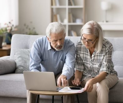 Two-seniors-reviewing-bills-and-debt-