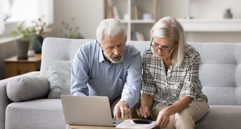 Two-seniors-reviewing-bills-and-debt-
