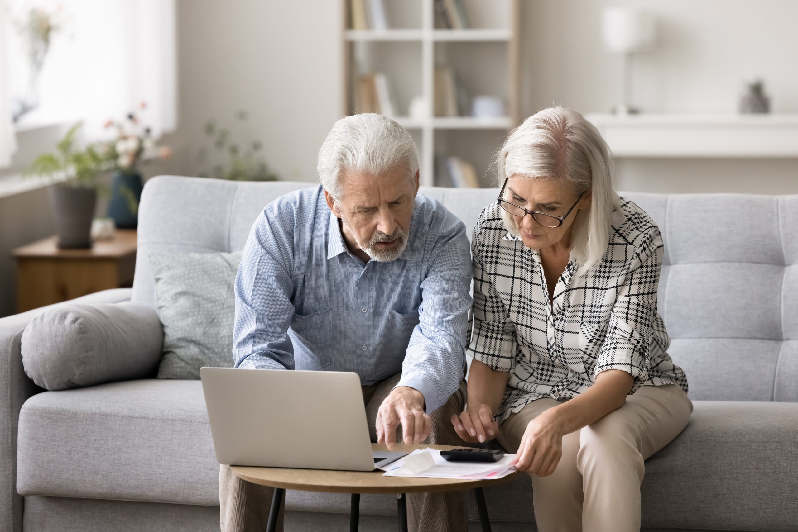 Two-seniors-reviewing-bills-and-debt-